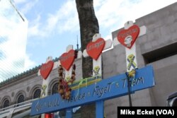 At 755 Boylston St., just a few steps from the finish line of the Boston Marathon, there is little indication of the carnage of the 2013 bombing, except for a small makeshift memorial tied to a narrow tree.