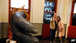 Visitors to the Empire State Building take a photo featuring an interactive King Kong exhibit, in New York, Thursday, Oct. 10, 2019. (AP Photo/Richard Drew)