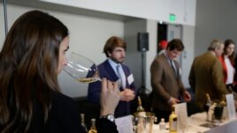 FILE: A woman tastes 2015 vintage wine tasting event January 25, 2018, in San Francisco.