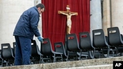 Workers install chairs in St. Peter's Square at the Vatican, March 18, 2013 for Pope Francis' Installation Mass on Tuesday. 