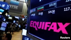FILE - The Equifax logo and trading information are displayed on the floor of the New York Stock Exchange in New York, Sept. 8, 2017. 