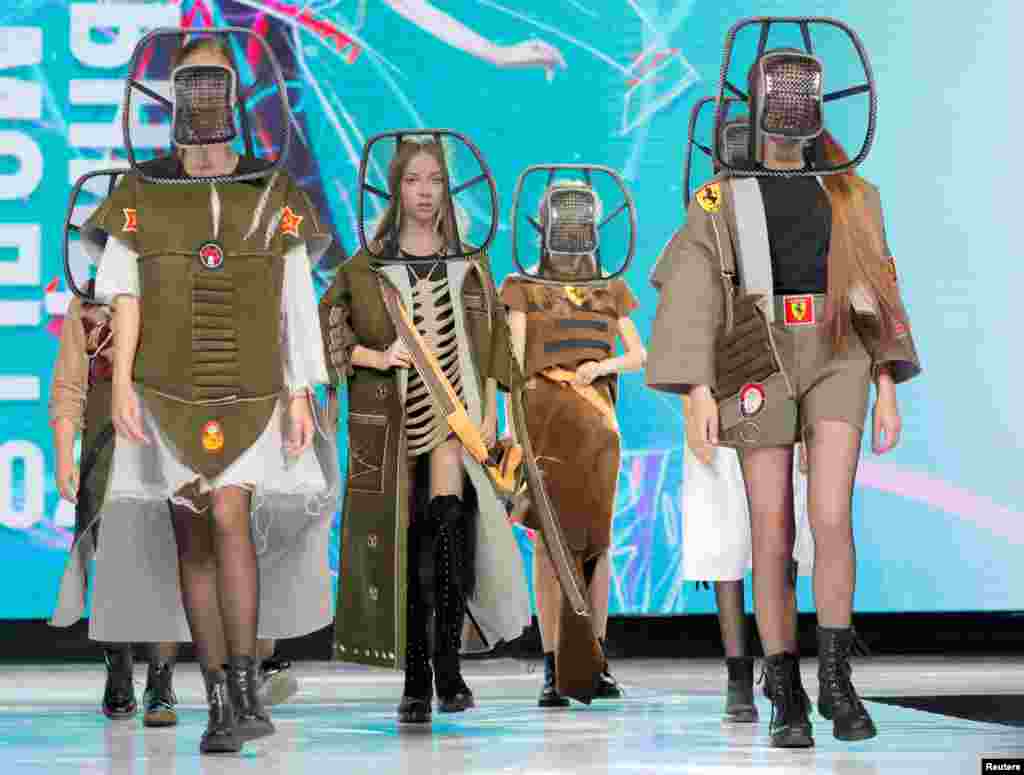 Models present creations &quot;2033 (teens)&quot; by Belarusian designer Anastasiya Kutepova during a show at the Fashion Mill, in Minsk.