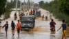 Residents wade through floodwaters fed by Typhoon Koppu at Zaragosa township, Nueva Ecija province, north of Manila, Philippines, Oct. 19, 2015. 