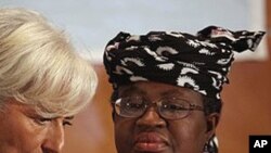 International Monetary Fund Managing Director Christine Lagarde, left, and Nigeria's Finance Minister Ngozi Okonjo-Iweala confer during roundtable meeting with Nigerian business executives in Lagos, Nigeria.