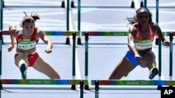 Puerto Rico's Jasmine Camacho-Quinn, right, and Belarus' Alina Talay compete in a women's 100-meter heat during the athletics competitions of the 2016 Summer Olympics at the Olympic stadium in Rio de Janeiro, Brazil, Tuesday, Aug. 16, 2016.
