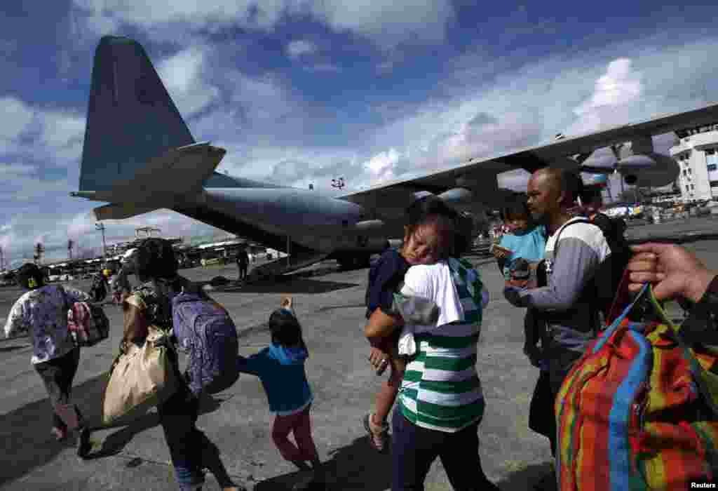 필리핀 정부가 국영 항공사와 군용기를 동원해 생존자들을 철수시키고 있는 가운데, 13일 타클로반 시의 생존들이 군용기를 타기 위해 이동하고 있다.