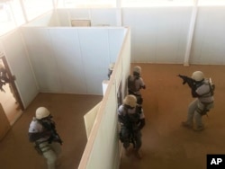 In this photo taken April 13, 2018. Nigerien police who are part of the U.S. Special Program for Embassy Augmentation and Response, known as SPEAR take part in the annual U.S.-led Flintlock exercise in Niamey, Niger.