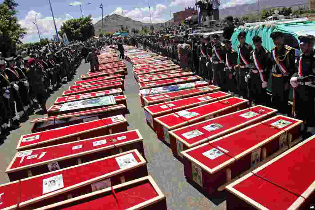 Houthi Shi'ite mourners attend the funeral procession of victims who were killed from a triple suicide bombing attack on mosques in Sana'a, Yemen.