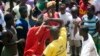 A youth is beaten with sticks after being accused of attempted theft in Monrovia, February 2007.