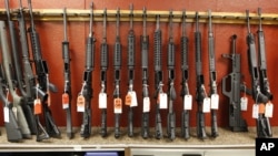 FILE - A rack of rifles is for sale at Firing-Line gun store in Aurora, Colo., June 27, 2013. A new poll conducted by The Associated Press-NORC Center for Public Affairs Research found that a majority of Americans favor stricter gun laws. 