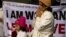 An Indian woman and her daughter pray as they take part in a silent protest to mourn the death of a gang rape victim in New Delhi, India, Tuesday, Jan. 1, 2013.