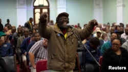 FILE - A man speaks as the Constitutional Review Committee holds public hearings regarding expropriation of land without compensation in Pietermaritzburg, South Africa, July 20, 2018.