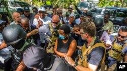 Martine Moise, center, the widow of slain President Jovenel Moise, arrives at the courthouse to give testimony in the investigation into the assassination of her husband, in Port-au-Prince, Haiti, Oct. 6, 2021.