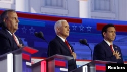Former New Jersey Governor Chris Christie, former U.S. Vice President Mike Pence and Florida Governor Ron DeSantis hold their hands over their hearts for the U.S. Pledge of Allegiance at the start of at the first Republican candidates' debate of the 2024 U.S. presidential campaign in Milwaukee, Wisconsin.