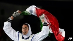 Kimia Alizadeh Zenoorin of Iran celebrates after winning the bronze medal in a women's Taekwondo 57-kgcompetition at the 2016 Summer Olympics in Rio de Janeiro, Brazil, Aug. 18, 2016.
