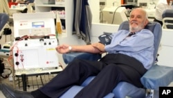 FILE - In this May, 2011 photo, donor James Harrison, credited with saving 2.4 million babies through his record-breaking blood plasma donations over decades, is giving blood at donation center in Sydney. (Australian Red Cross Lifeblood via AP)