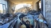 A portrait of Hezbollah chief Hassan Nasrallah sits amid destruction in an area targeted overnight by Israeli airstrikes in Saksakiyeh, Lebanon, on Sept. 26, 2024.