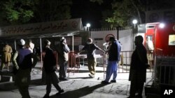 Afghans wait outside a hospital to see relatives in Kabul, Afghanistan, April 30, 2021. A powerful suicide truck bombing struck a guest house in eastern Afghanistan on Friday, killing dozens and wounding as many as 90, the Interior Ministry said.