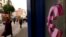 FILE - A sign displaying the euro symbol is seen on a shop window in Dublin, Oct. 22, 2014. 