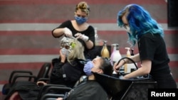 Trabajadoras del Three-13 Salon, Spa and Boutique en Marietta, estado de Georgia, lavan el cabello a clientes durante la reapertura gradual de negocios y restaurantes, luego de la relajación de las restricciones tomadas por la COVID-19. Abril 24 de 2020.