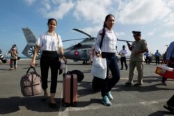 Cambodian medical officers arrive for health checks on passengers and crew of the cruise ship Westerdam in Sihanoukville, Cambodia, Feb. 13, 2020.