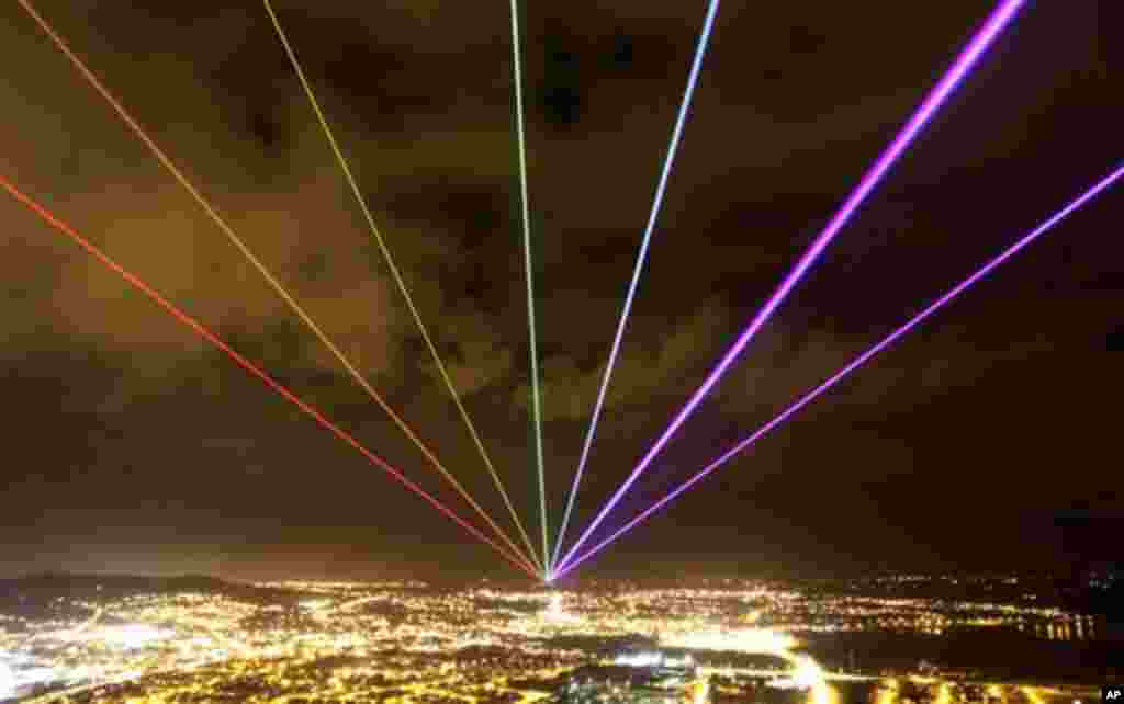 The Global Rainbow is projected into the night sky from Scrabo Tower, Newtownards, Northern Ireland, Friday, March 16, 2012. The large scale outdoor laser projection created by New York artist Yvette Mattern is visible across the night sky, the event sig
