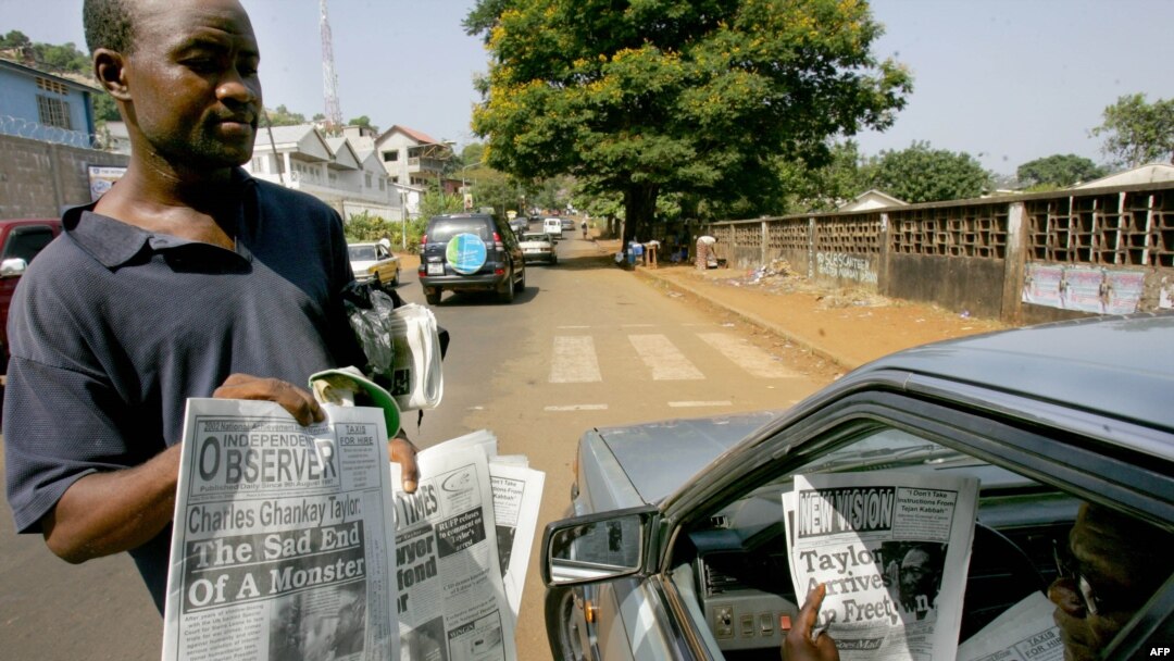 A man checks headlines of Sierra Leonean newspapers in Freetown. File photo.