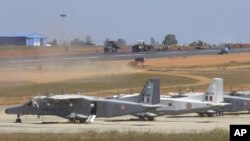Dornier 228 aircrafts lie parked as construction work continues at the Yelahanka Air Force Station near Bangalore, India, Friday, Dec. 24, 2004. The Air Force Station is the venue for the 5th Air Show due to be held in Feb. 2005, in which U.S. military ai