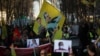 FILE - Pro-Kurdish people wave flags with the face of jailed Kurdistan Workers' Party, or PKK, leader Abdullah Ocalan during a protest demanding his freedom in Brussels, Feb. 27, 2019. 