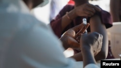 A Nigerian health official prepares to administer an mpox vaccination at Federal Medical Center in Abuja, Nigeria, Nov. 18, 2024. 