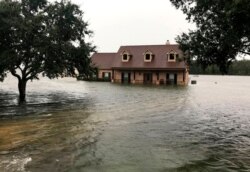 Floodwaters surround a home in Winnie, Texas, Sept 19, 2019.
