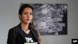 Mariana Molero wears a "TPS for Venezuelans" t-shirt as she poses for a photo at her home in Pembroke Pines, Fla., Jan. 22, 2021. Molero and her husband left Venezuela in 2005.