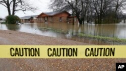 Caution tape closes off this neighborhood in Drew, Miss., Friday, March 11, 2016, as floodwaters have affected areas in the Delta. The flooding has affected the Delta to varying degrees. Additional rain is expected to continue through Saturday.