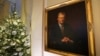 FILE - A Christmas tree stands beside a painting of former U.S. President Jimmy Carter at the White House in Washington, Nov. 27, 2023.