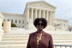 FILE - Doreen Oport, who was injured in the attack on the U.S. Embassy in Nairobi in 1998, stands outside the U.S. Supreme Court after oral arguments in Washington, Feb. 24, 2020.