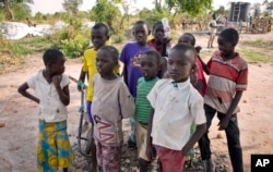 FILE - In this photo taken Monday, March 12, 2018, South Sudanese refugee children gather near a water point in the Rhino refugee settlement, near Arua, in northern Uganda.