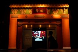 A screen shows the ceremony of British handover Hong Kong to China, at the exhibition "The Hong Kong Story" in the Hong Kong Museum of History, Oct. 16, 2020.