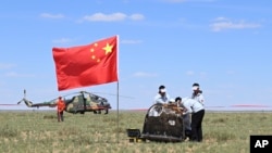 In this photo released by Xinhua News Agency, workers access the returned capsule of the Chang'e 6 probe in Siziwang Banner, northern China's Inner Mongolia Autonomous Region on June 25, 2024.