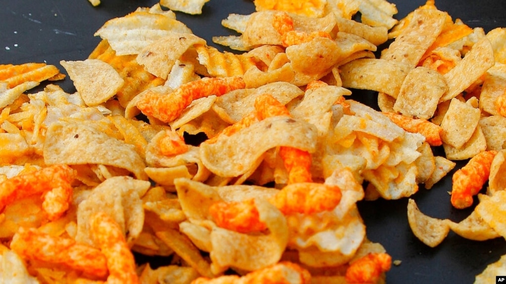 A mixture of salty snacks and chips is shown. The U.S. FDA recently announced new goals to help Americans reduce their sodium intake. (AP Photo/Keith Srakocic)