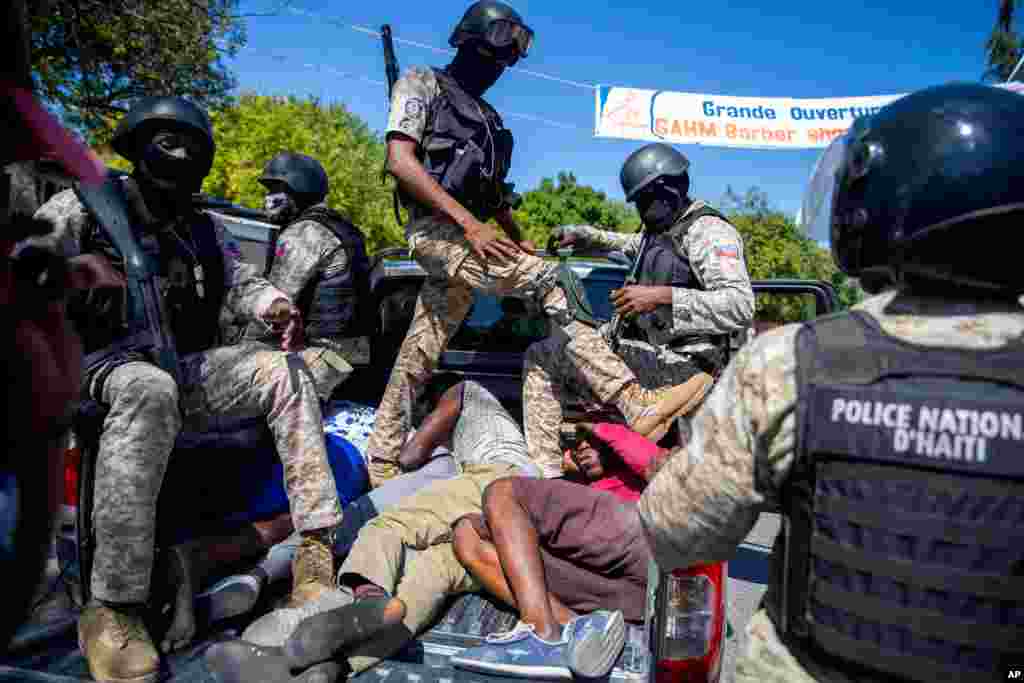 Police detain demonstrators during a protest to demand the resignation of Haitian President Jovenel Moise in Port-au-Prince, Feb. 7, 2021.