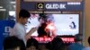 FILE - People watch a TV showing a file image of North Korea's missile launch during a news program at the Seoul Railway Station in Seoul, South Korea, Oct. 2, 2019. North Korea fired projectiles toward its eastern sea, South Korea's military said. 