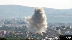 This picture taken from Lebanon's southern city of Tyre shows a cloud of smoke erupting following an Israeli air strike on the village of Sammaiyah on October 14, 2024.