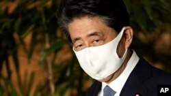 Former Japan's Prime Minister Shinzo Abe wears a face mask in August 2020, in Tokyo, shortly before he stepped down.