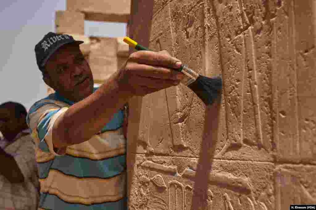 Abdul-Nasser, an Egyptian archaeological worker, restores relief drawings on the walls of Karnak temple in Luxor, Egypt, April 20, 2018.