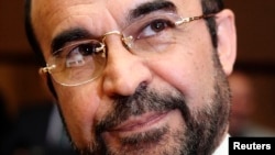 Iran's new ambassador to the International Atomic Energy Agency (IAEA) Reza Najafi smiles as he arrives for a board of governors meeting at the IAEA headquarters in Vienna, Sept., 2013.