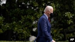 President Joe Biden walks on the South Lawn of the White House in Washington, March 23, 2021, before boarding Marine One.