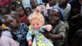A Congolese girl, displaced by recent fighting in North Kivu, holds a doll at the child friendly space (CFS) within Mugunga III camp for the internally displaced people near Goma, eastern Democratic Republic of Congo.