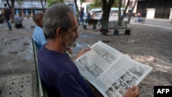 FILE - A man reads a Cuban newspaper in Havana, May 19, 2018.