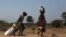 Women carry food at a food distribution site in Nyal, Unity State, Apr.1, 2014.  