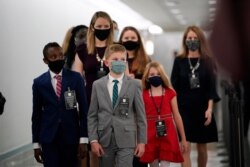 The children of Supreme Court nominee Amy Coney Barrett arrive on Capitol Hill before she begins her confirmation hearing before the Senate Judiciary Committee, on Capitol Hill in Washington, Oct. 12, 2020.